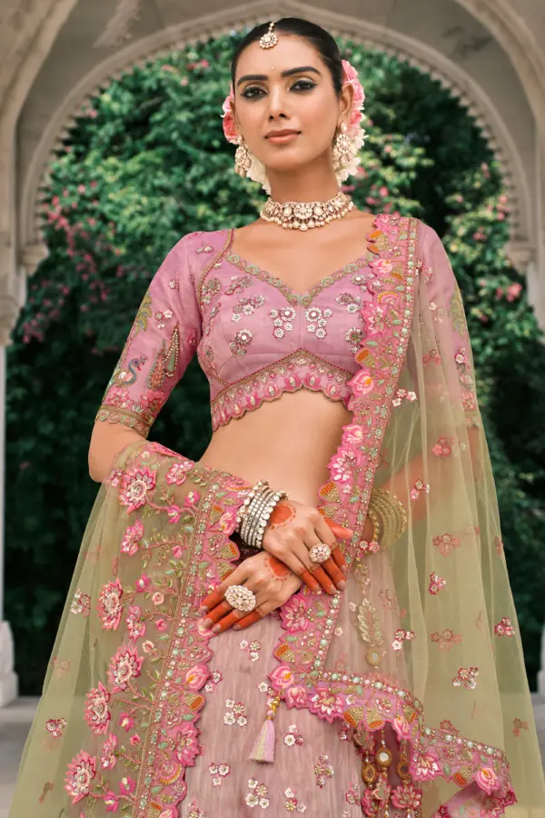 Close-up of stone work on pink and green lehenga