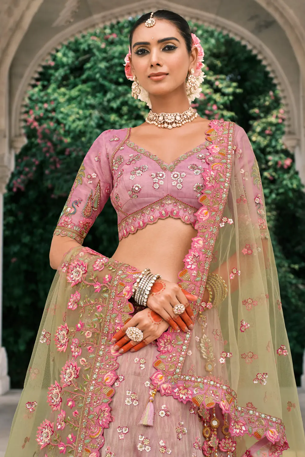 Close-up of stone work on pink and green lehenga