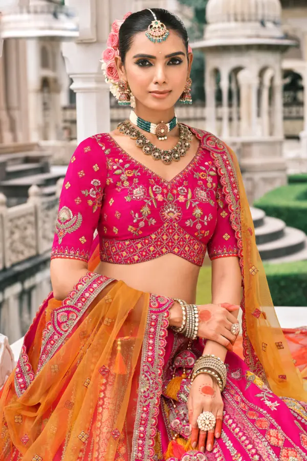 Close-up of stone and mirror work on pink silk lehenga