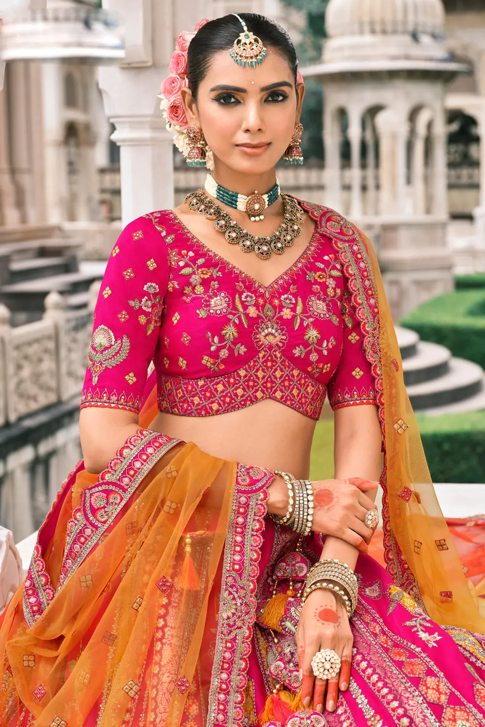 Close-up of stone and mirror work on pink silk lehenga