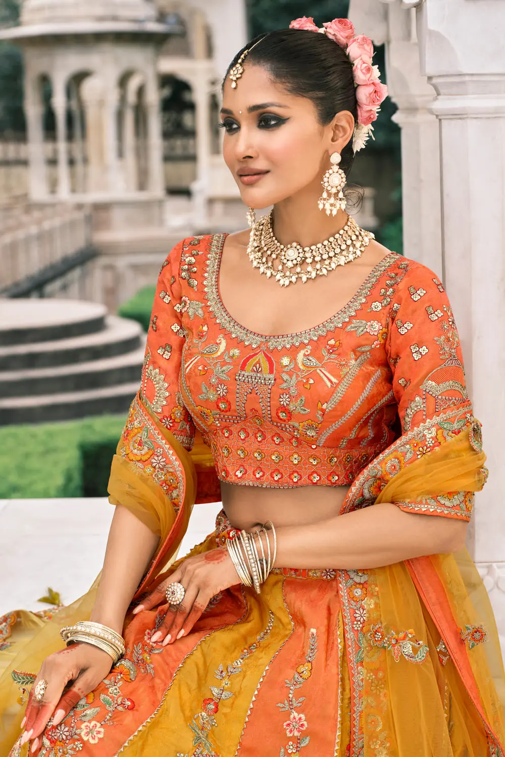 Orange and yellow lehenga modeled for wedding ceremony