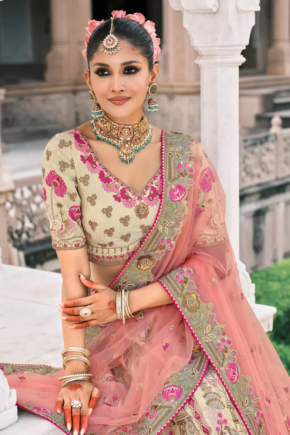Close-up of stone and mirror work on ivory bridal lehenga