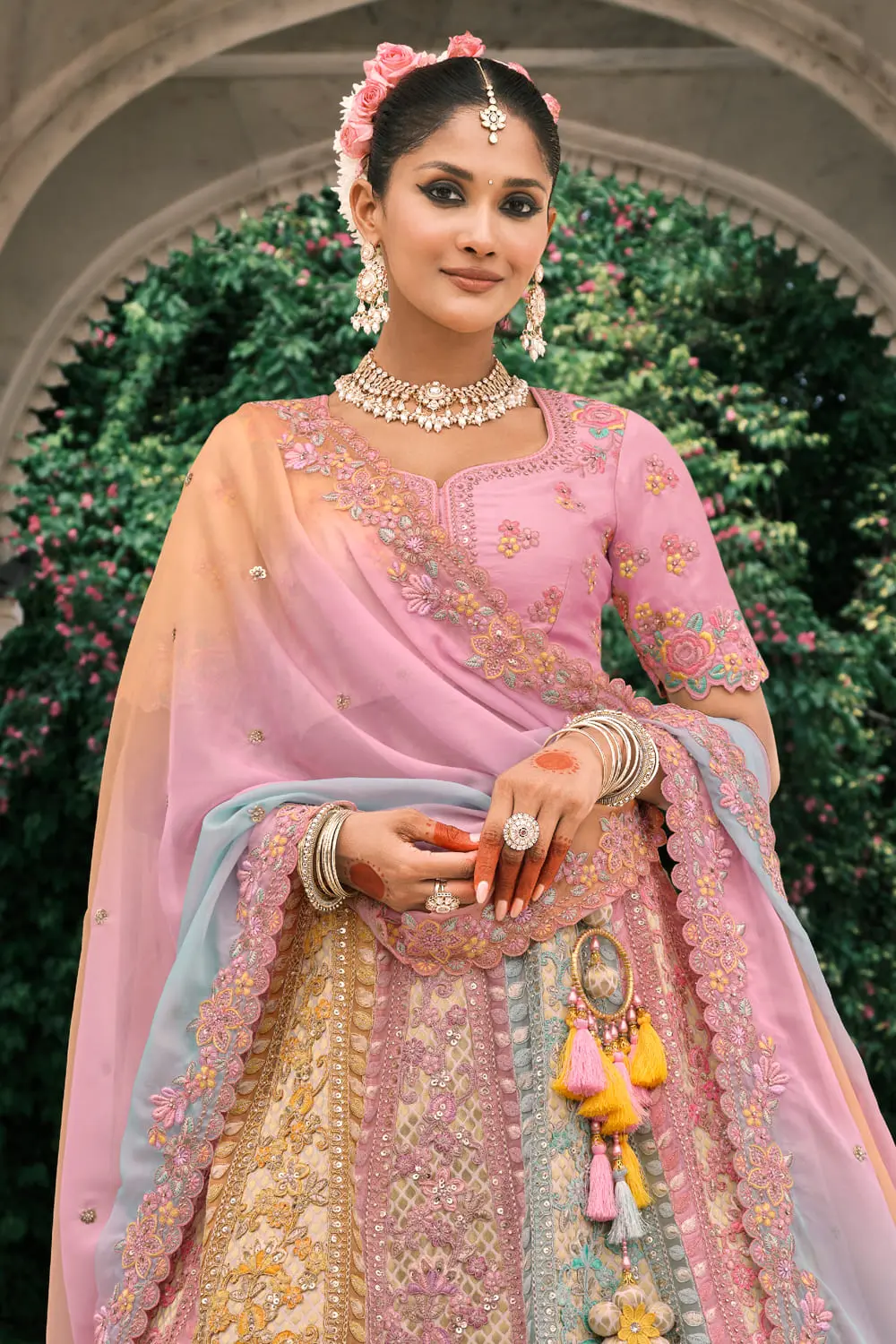 Close-up of stone and mirror work on dusty rose lehenga