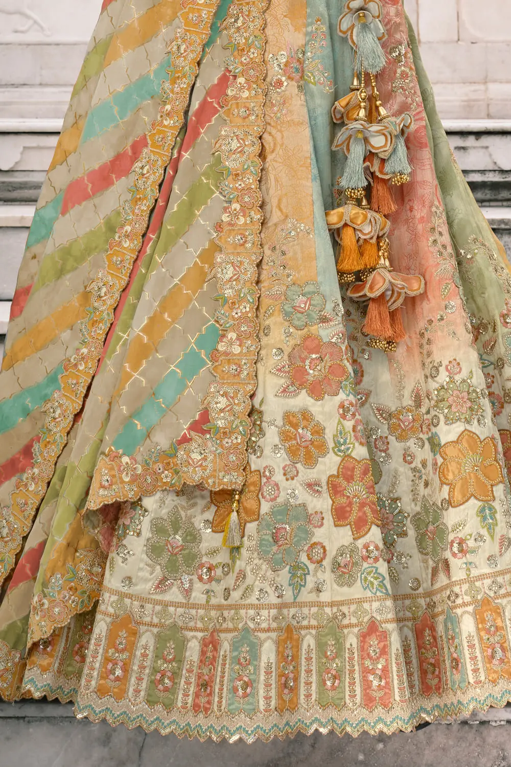 Back detail of cream bridal lehenga with intricate patterns