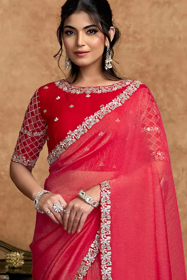 Close-up of intricate stone and sequin work on red shimmer saree
