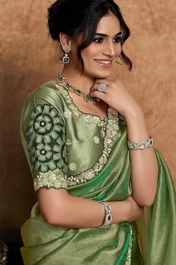 Model wearing green festive saree with elegant styling