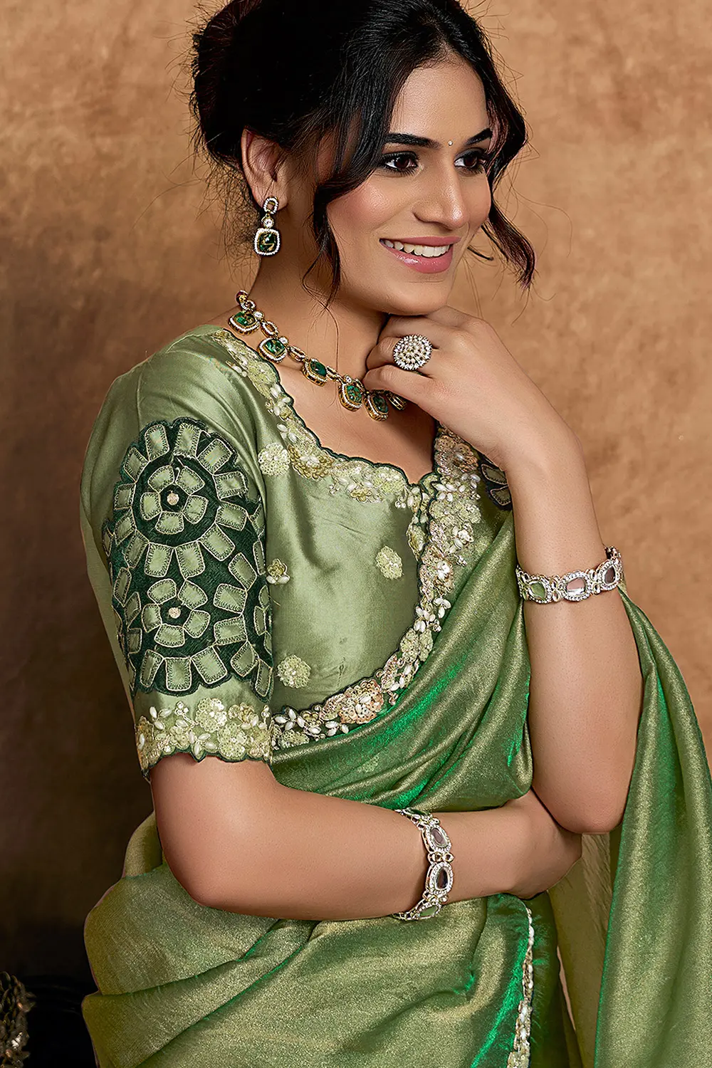 Model wearing green festive saree with elegant styling