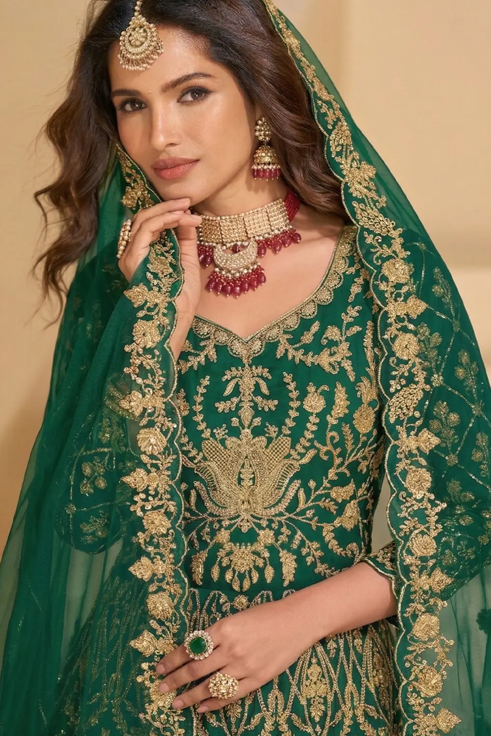 Model wearing the Designer Silk Anarkali gown with traditional jhumkas and minimalist styling.
