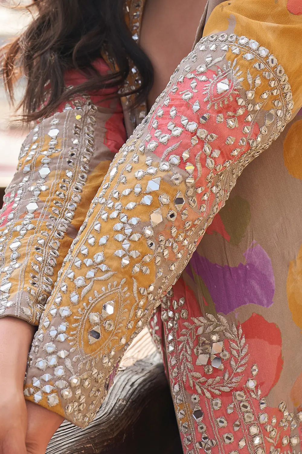 Heavy mirror embroidery on Orange Sharara Suit jacket – close shot