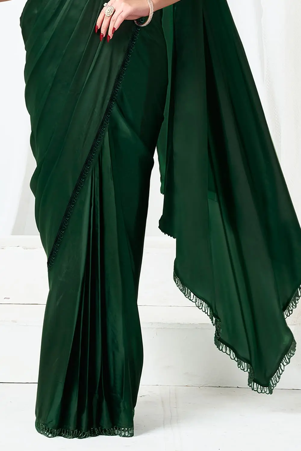Green party wear saree with jacket worn open – three-quarter sleeve detail and beadwork