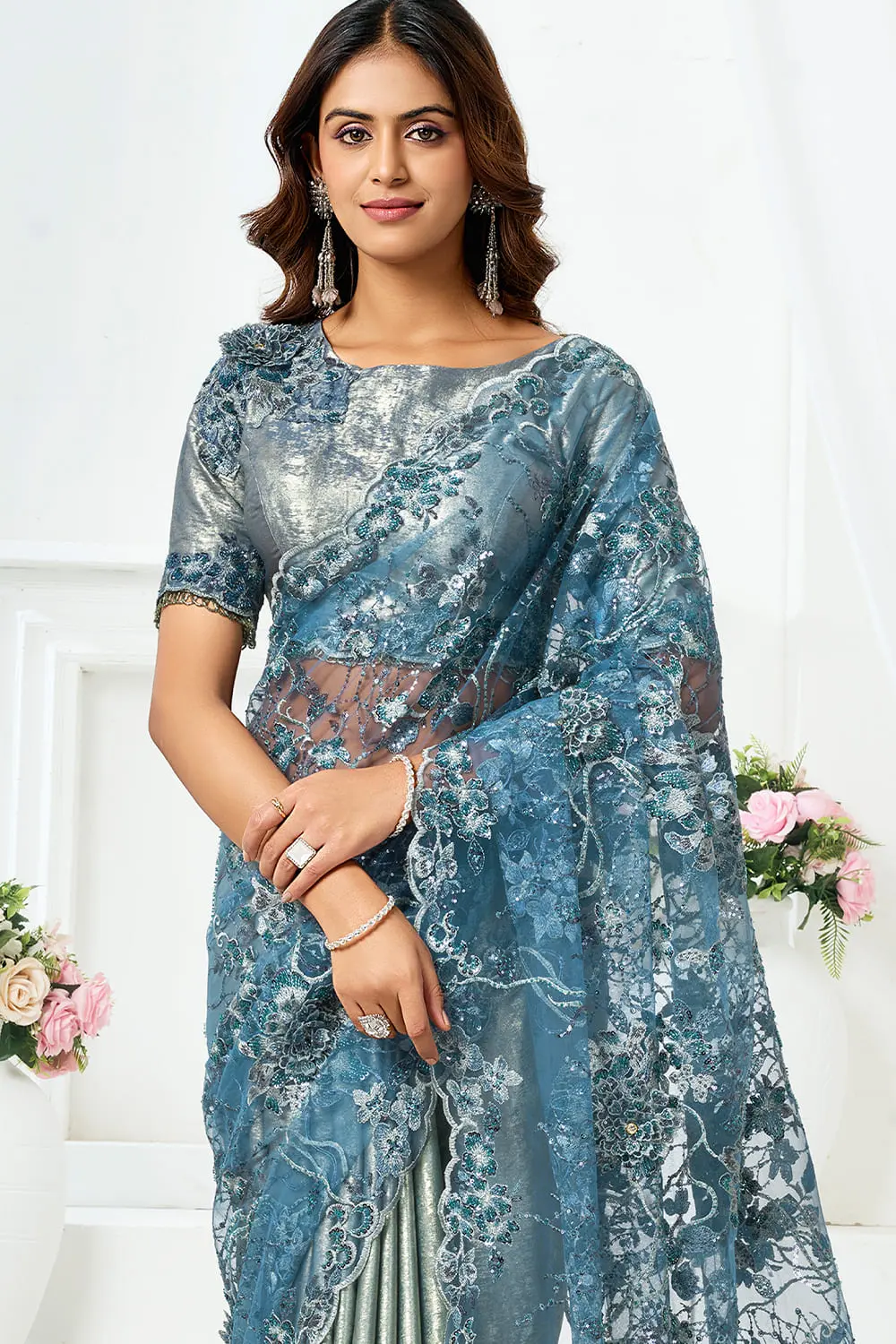 Close up of beads cut dana and embroidery on dusty blue engagement saree for bride