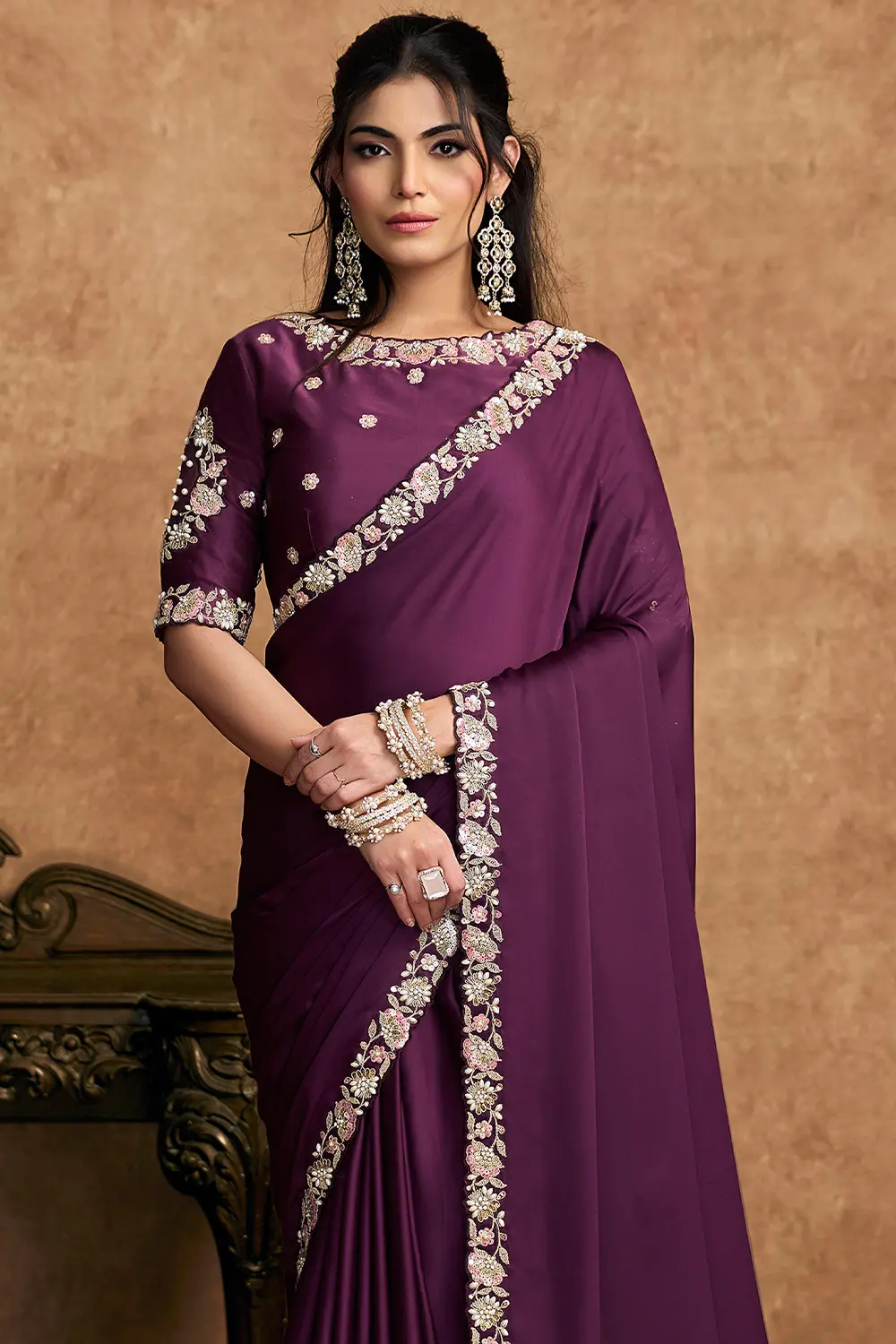 Close-up of pearl and stone detailing on wine saree