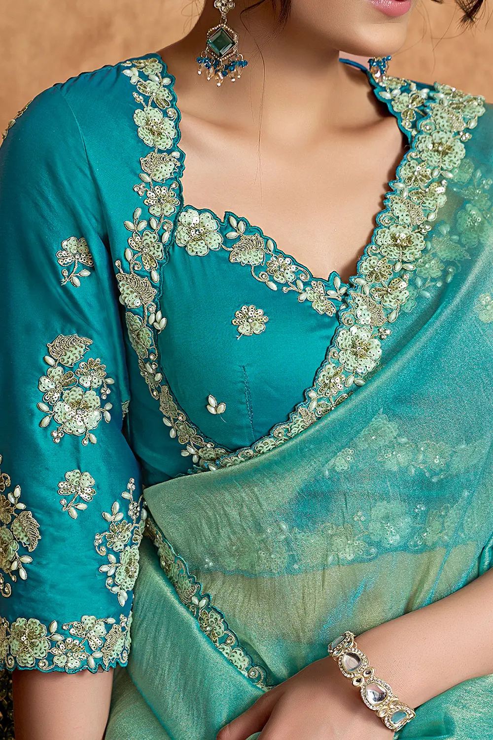 Model wearing turquoise festive saree
