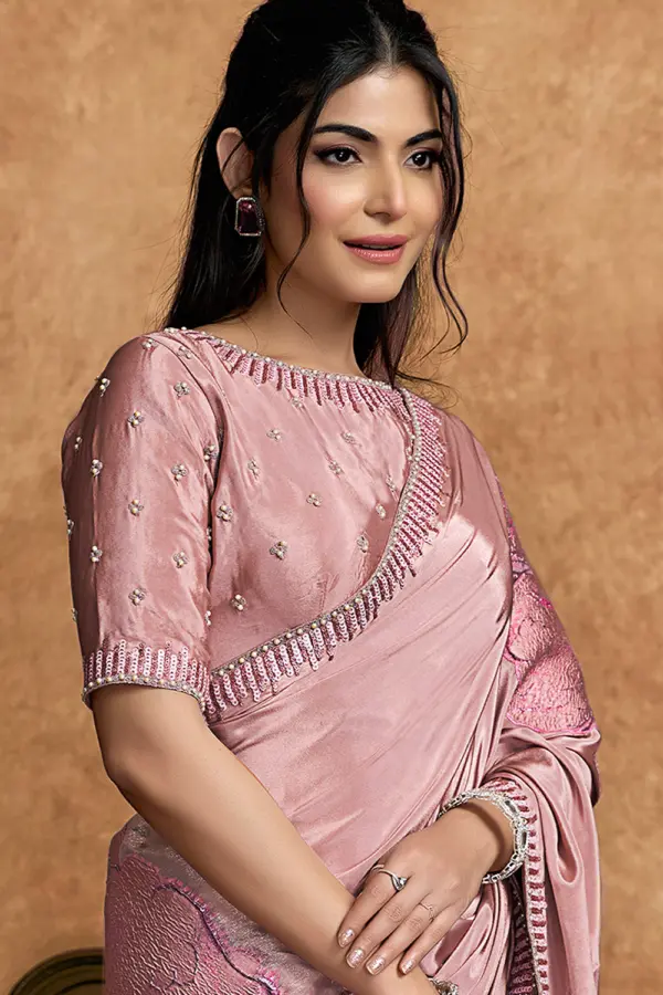 Close-up of sequin and pearl detailing on pink saree