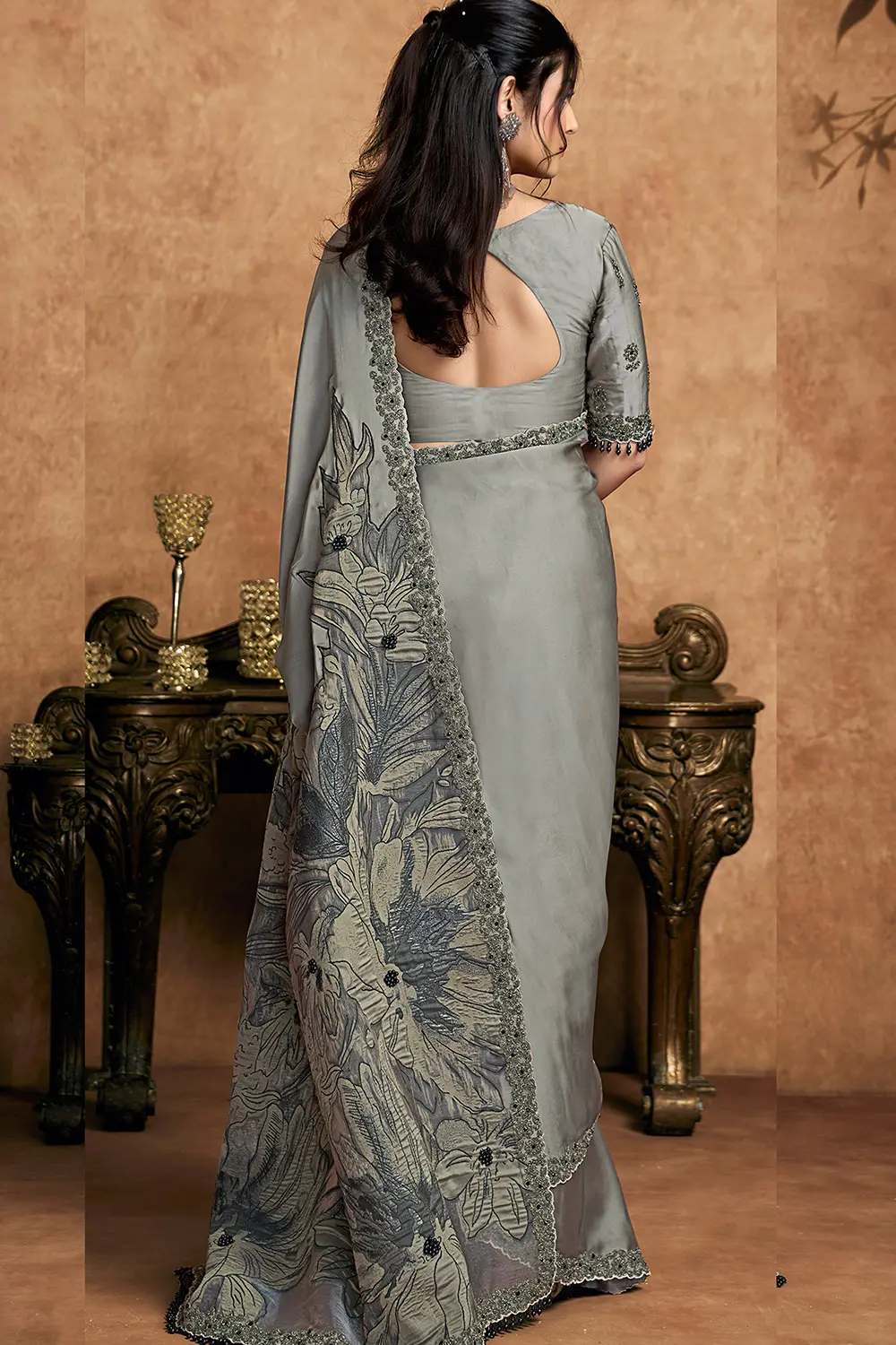 Model wearing steel grey festive saree with modern styling