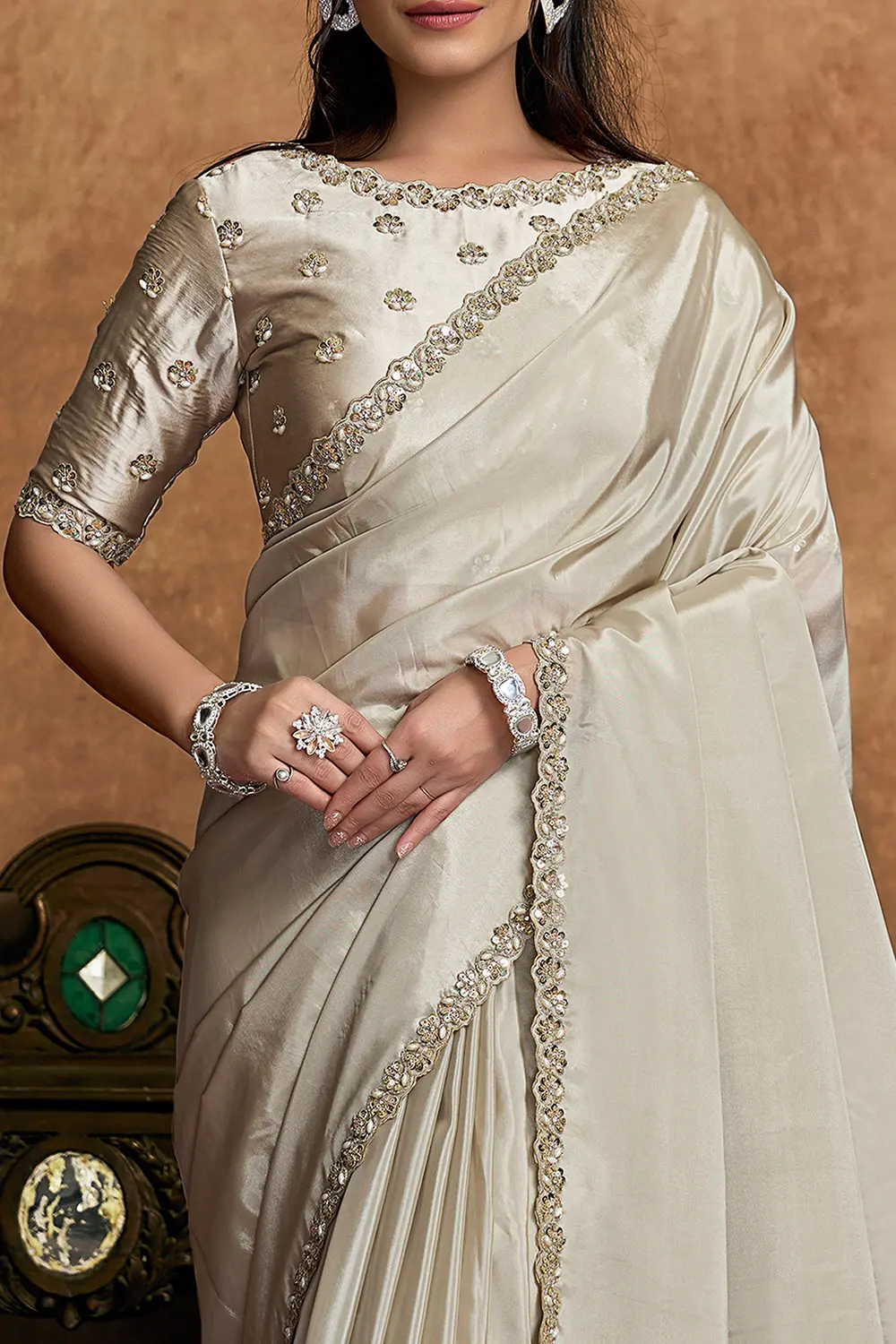Model wearing champagne ivory festive saree with elegant styling
