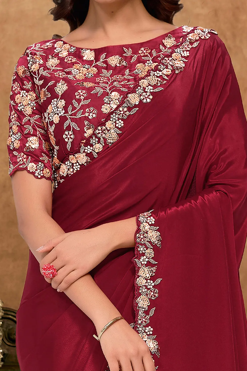 Model wearing deep maroon festive saree with elegant styling