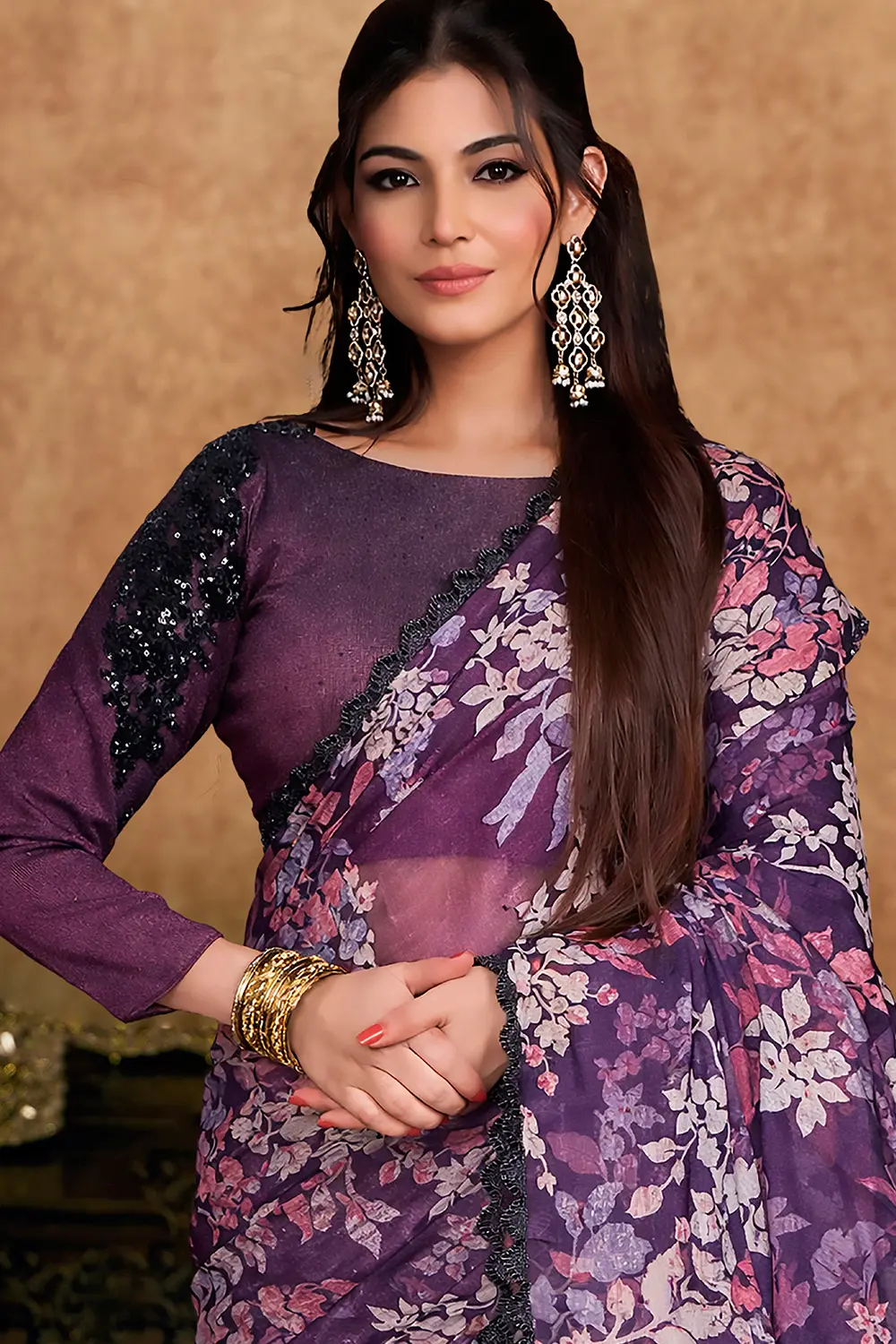 Close-up of pearl and stone work on plum saree