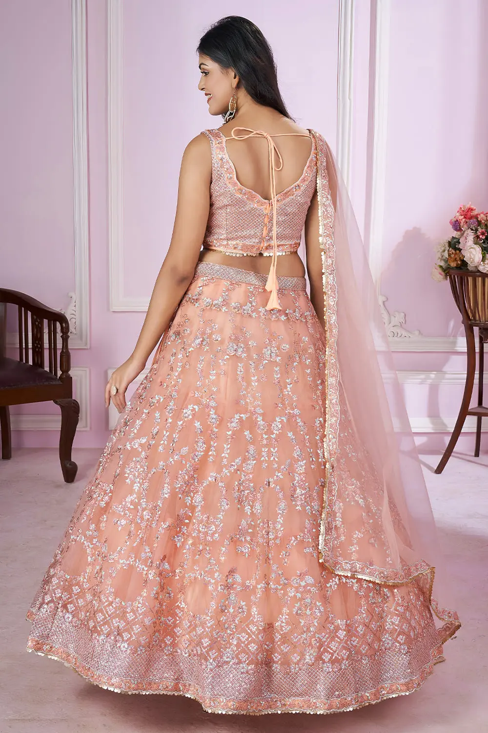 Back side of dusty pink lehenga showing dupatta drape and soft net fall