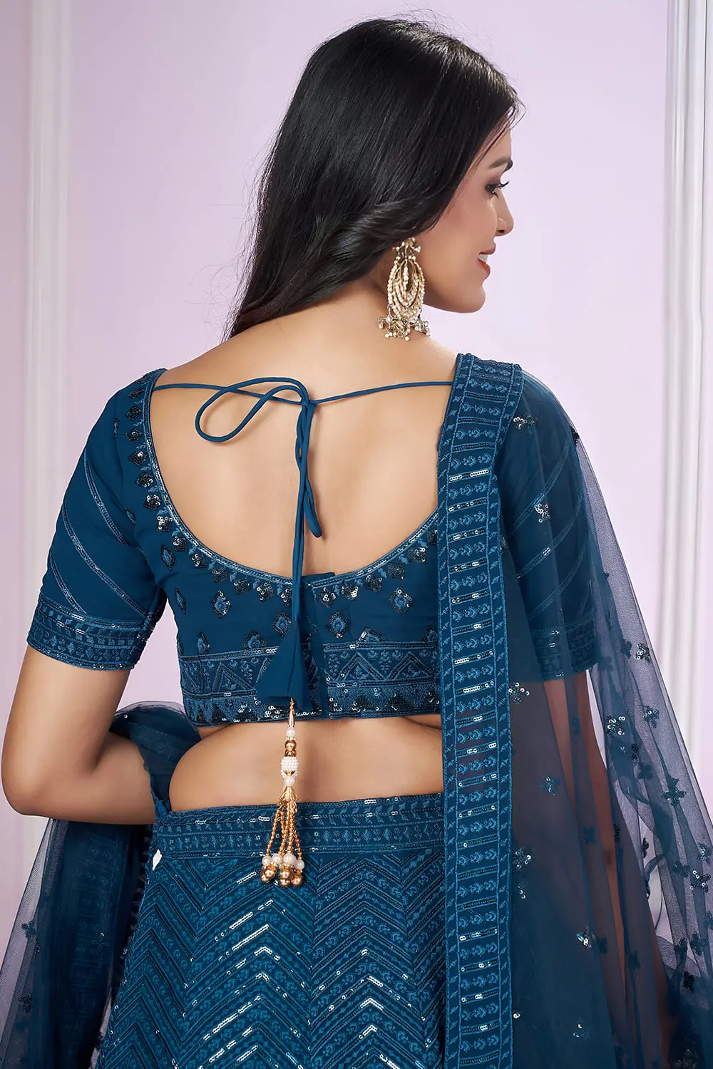 Model wearing Prussian Blue lehenga for wedding guest look at Khaish studio