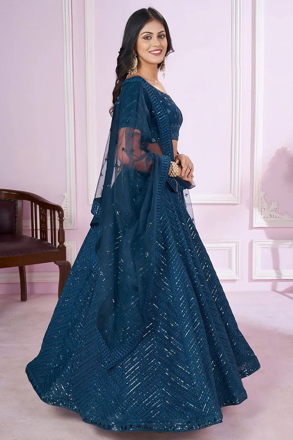 Side angle of Prussian Blue georgette lehenga showing soft net dupatta drape