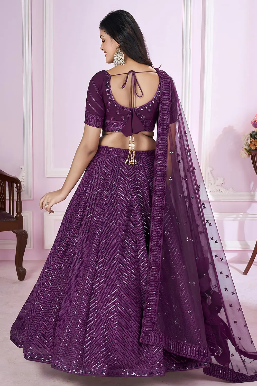Back view of purple lehenga for wedding with dupatta and zari hemline details