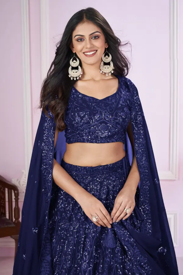 Close up of sequin and thread embroidery on navy blue lehenga choli blouse piece