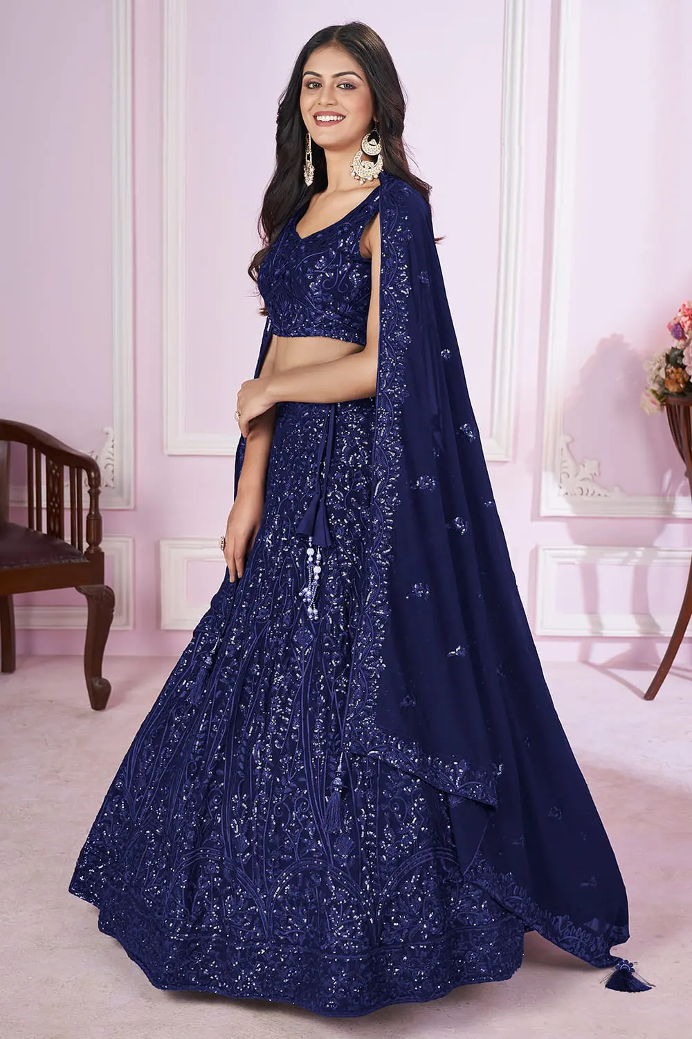 Side angle of navy blue georgette lehenga set with soft net dupatta drape