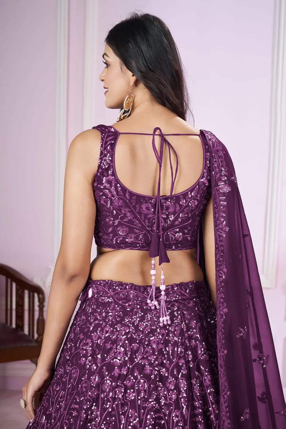 Model wearing purple lehenga dress for wedding party occasion at Khaish studio