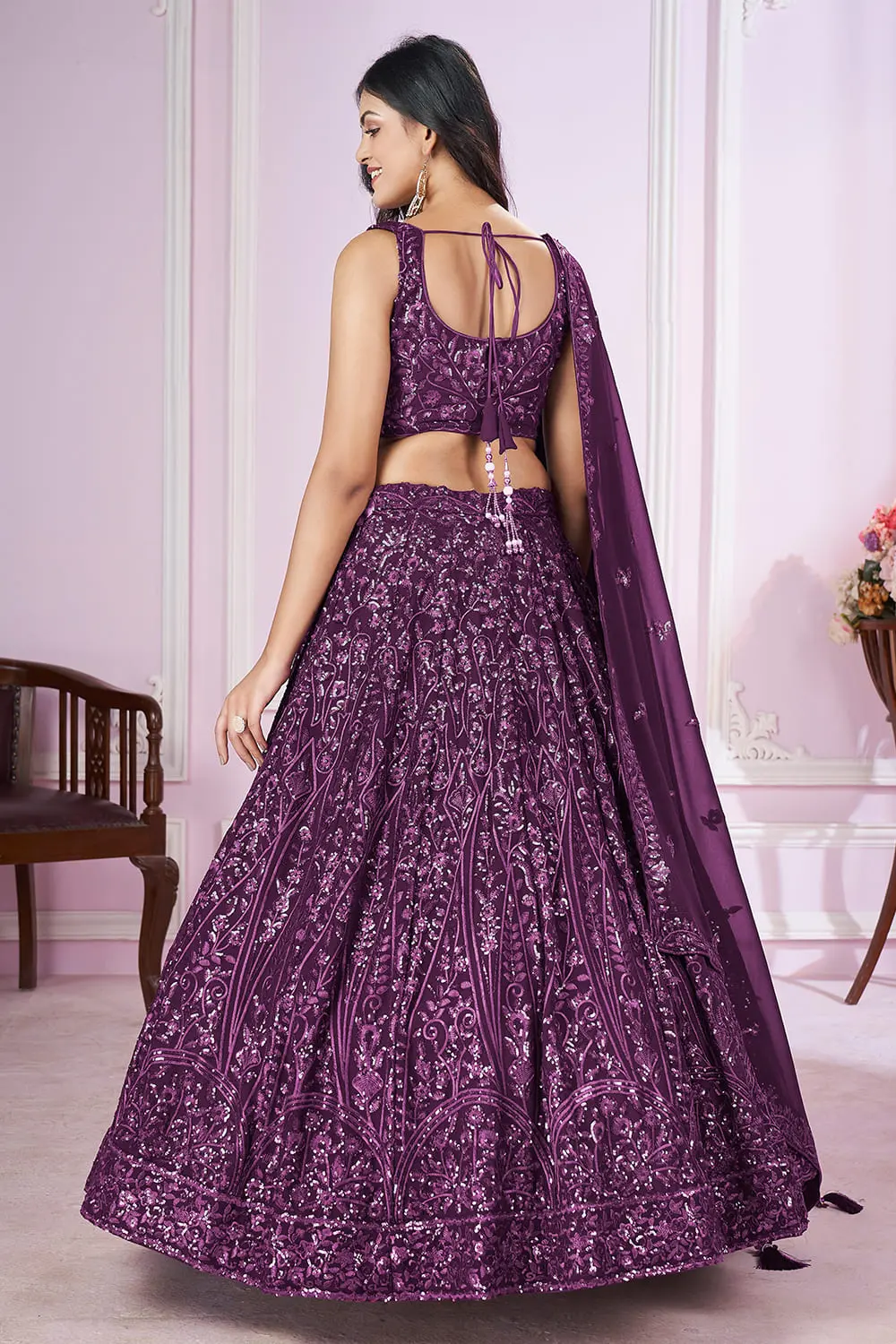 Back view of purple bridal lehenga with dupatta and zari hemline details