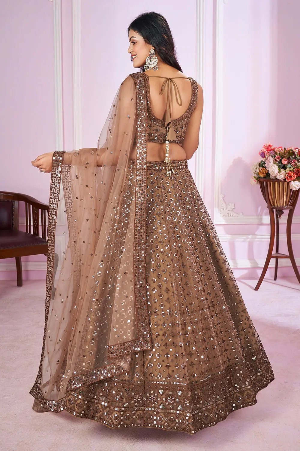 Back view of Brown Lehengas set with dupatta and zari hemline details