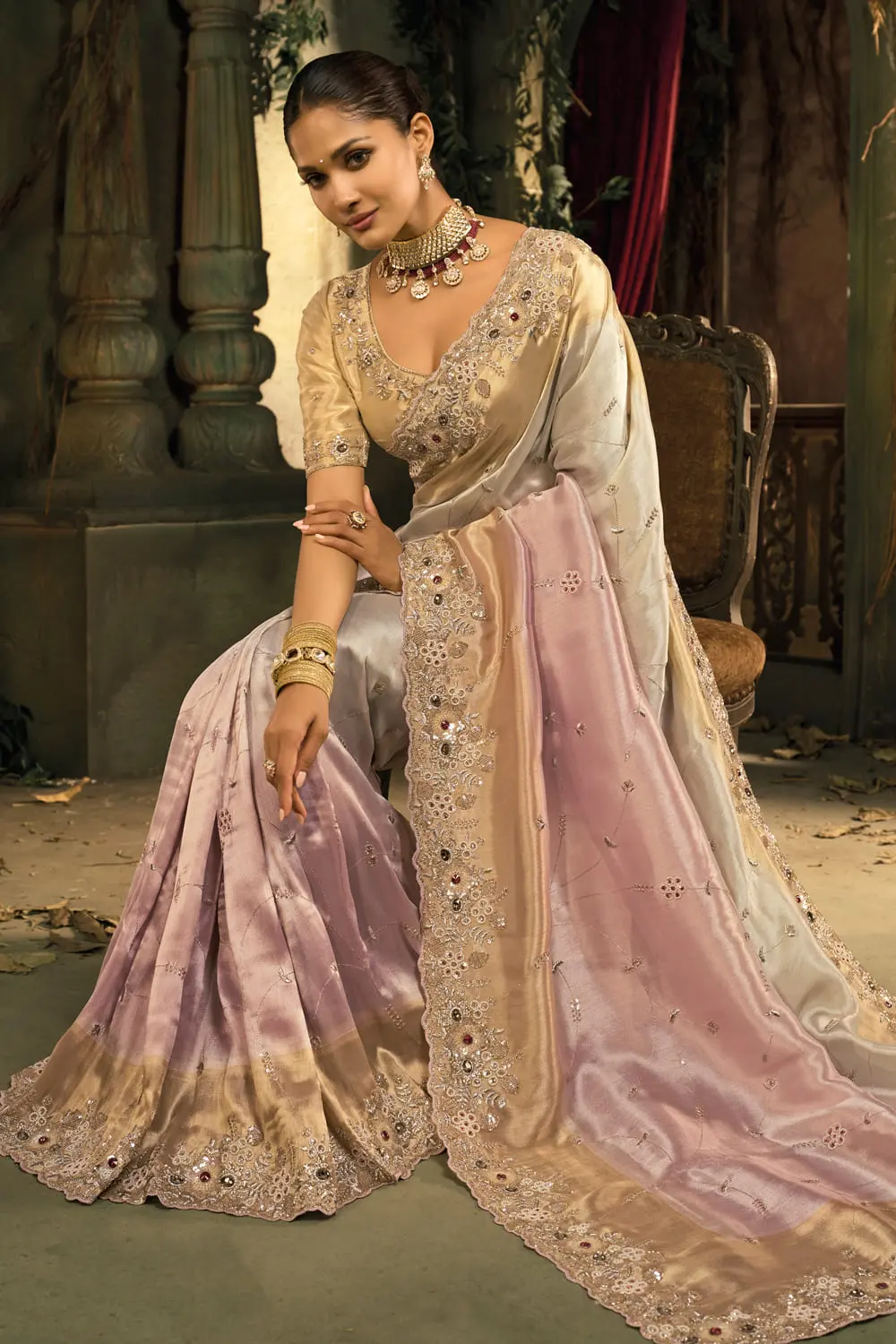 Moti and emerald heavy work detail on pink ombré silk saree pallu