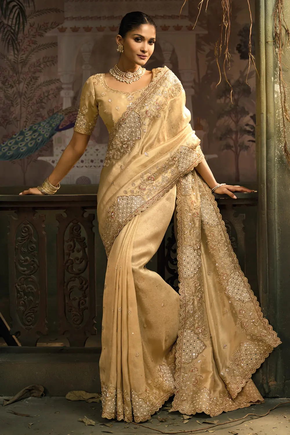 Gold banarasi silk saree folded with blouse piece showing heavy work