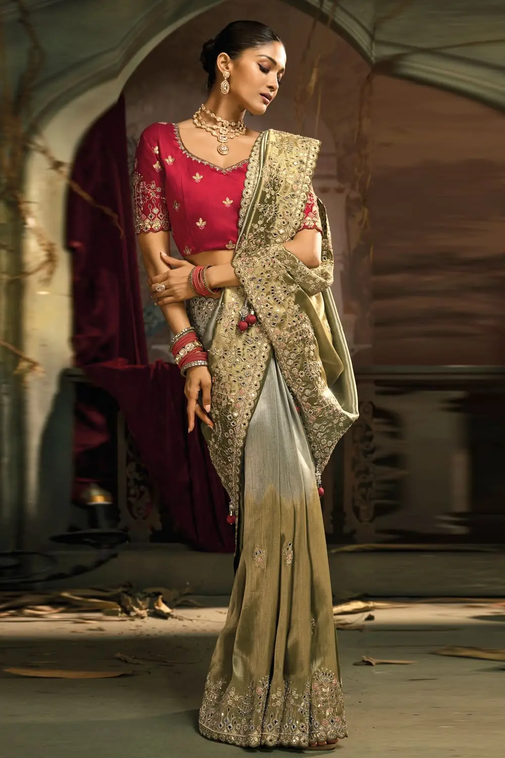 Mirror and jarkhan detail on pallu of olive green silk saree