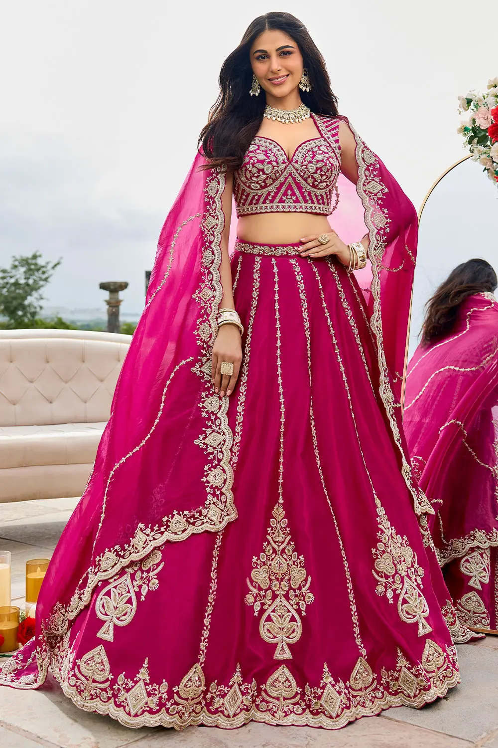 Hot pink lehenga hemline showing thread cutwork border and silk texture