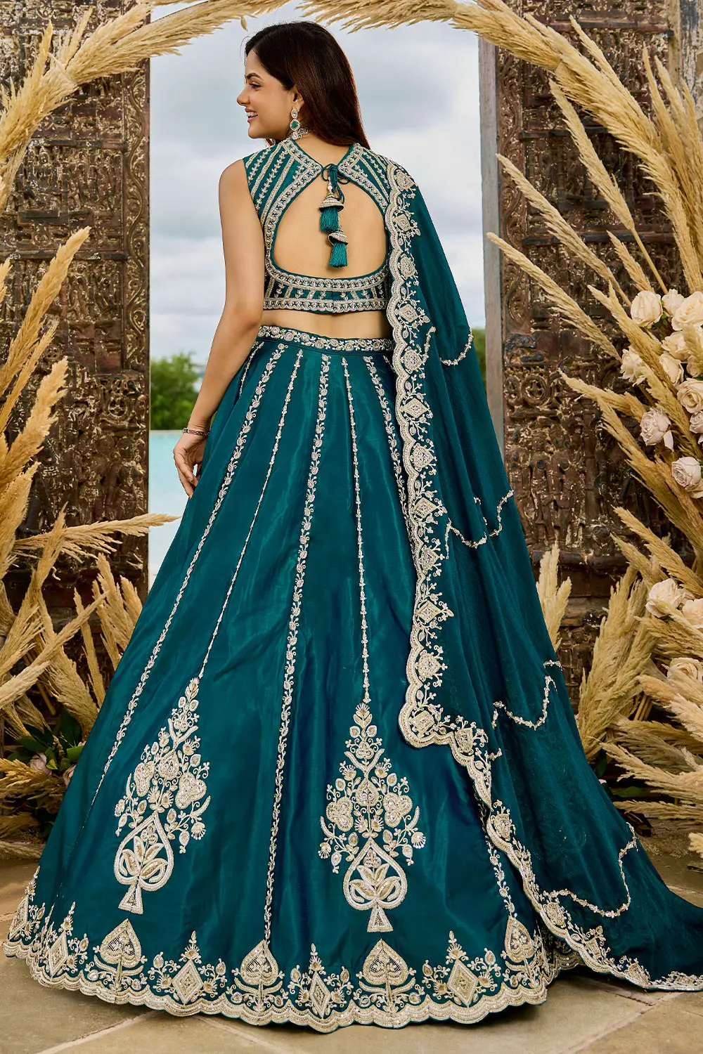 Back flare view of teal blue lehenga highlighting full flair and volume