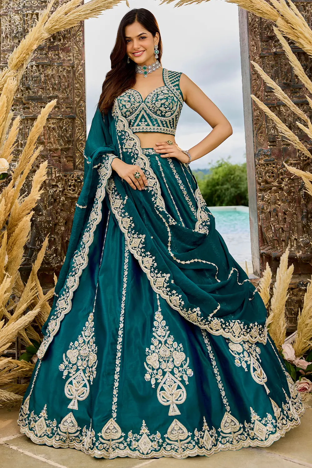 Teal blue lehenga set displayed flat – silk fabric with sequin and coding work