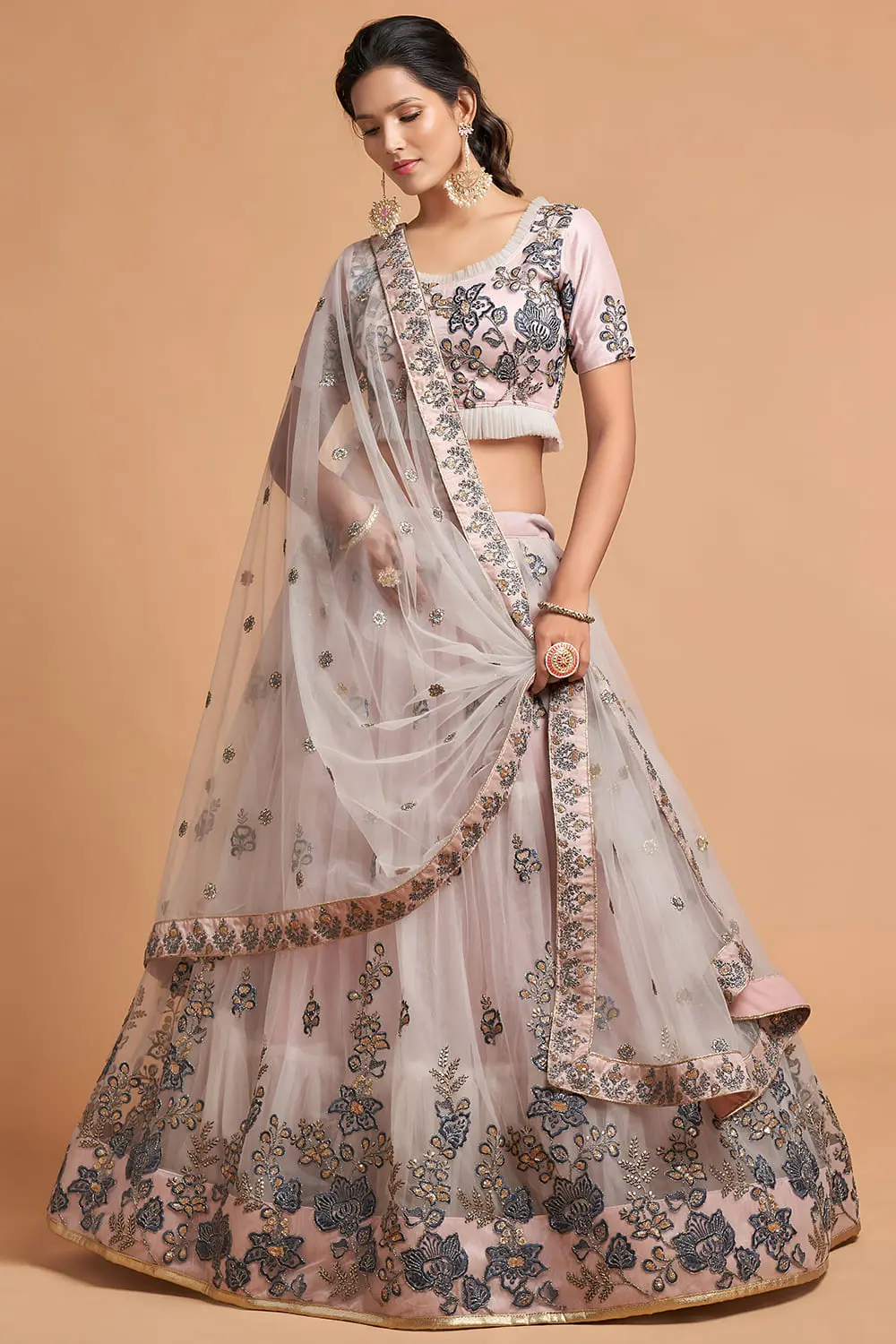 Grey Soft Net Lehenga skirt swirling in motion, revealing its soft net layers.