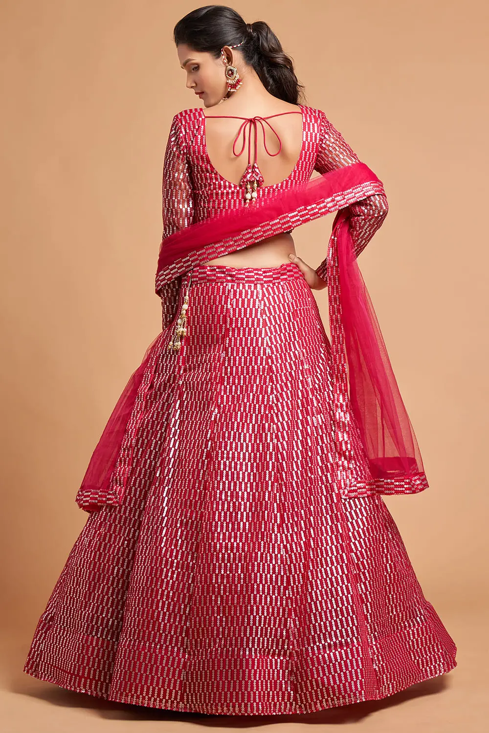 Side-angle showing the Pink Net Lehenga blouse design with sheer back and full sleeves.