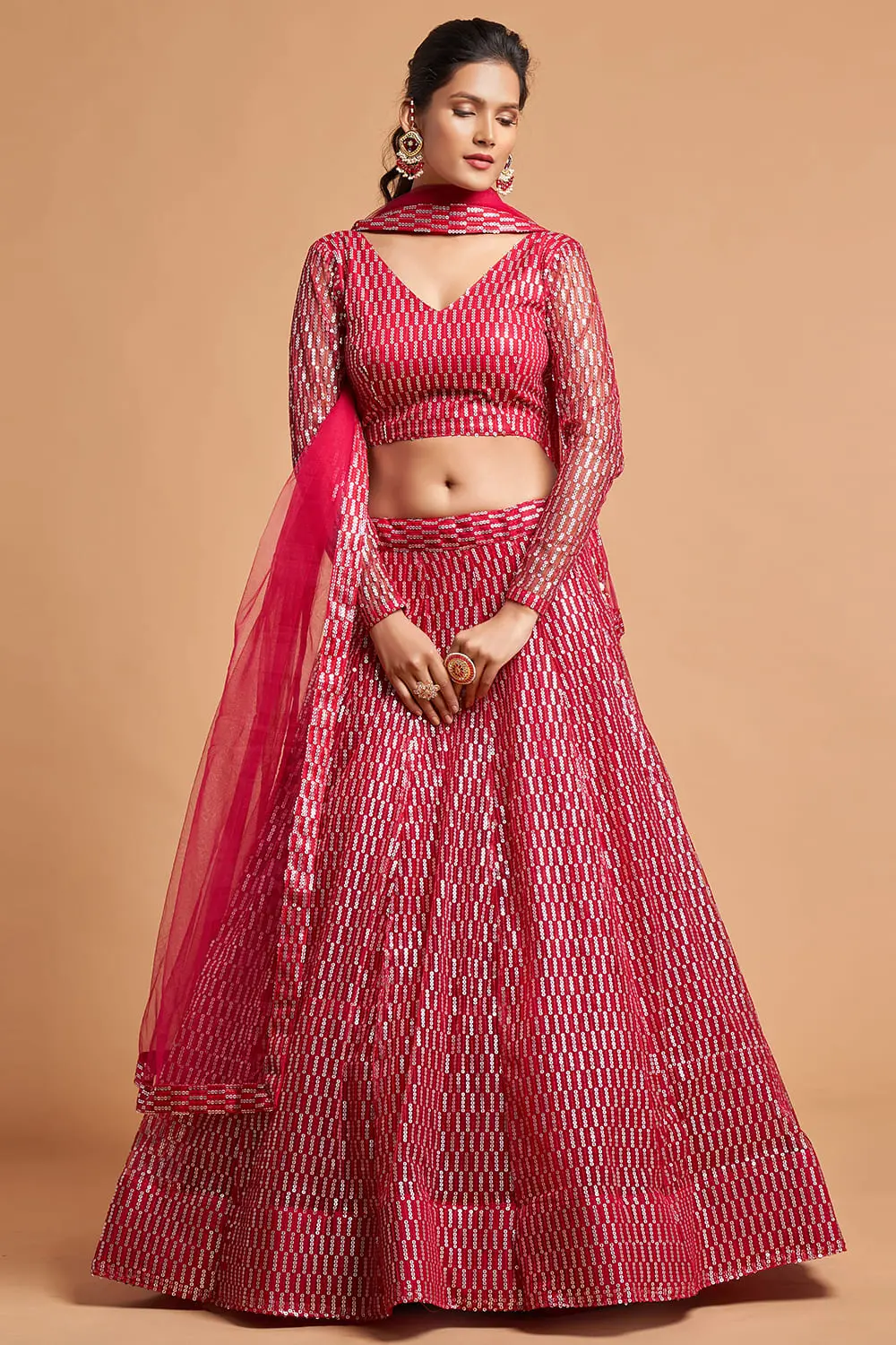 The Pink Net Lehenga set laid flat with pink dupatta, floral jewellery, and potli bag.
