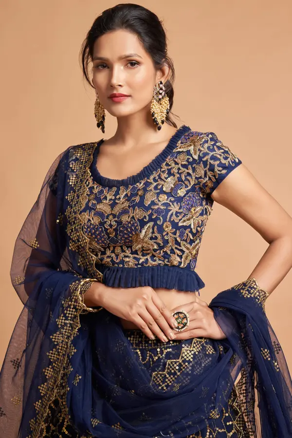 Close-up of the golden zari constellation motifs and multi-sequin work on the Navy Blue Net Lehenga skirt.