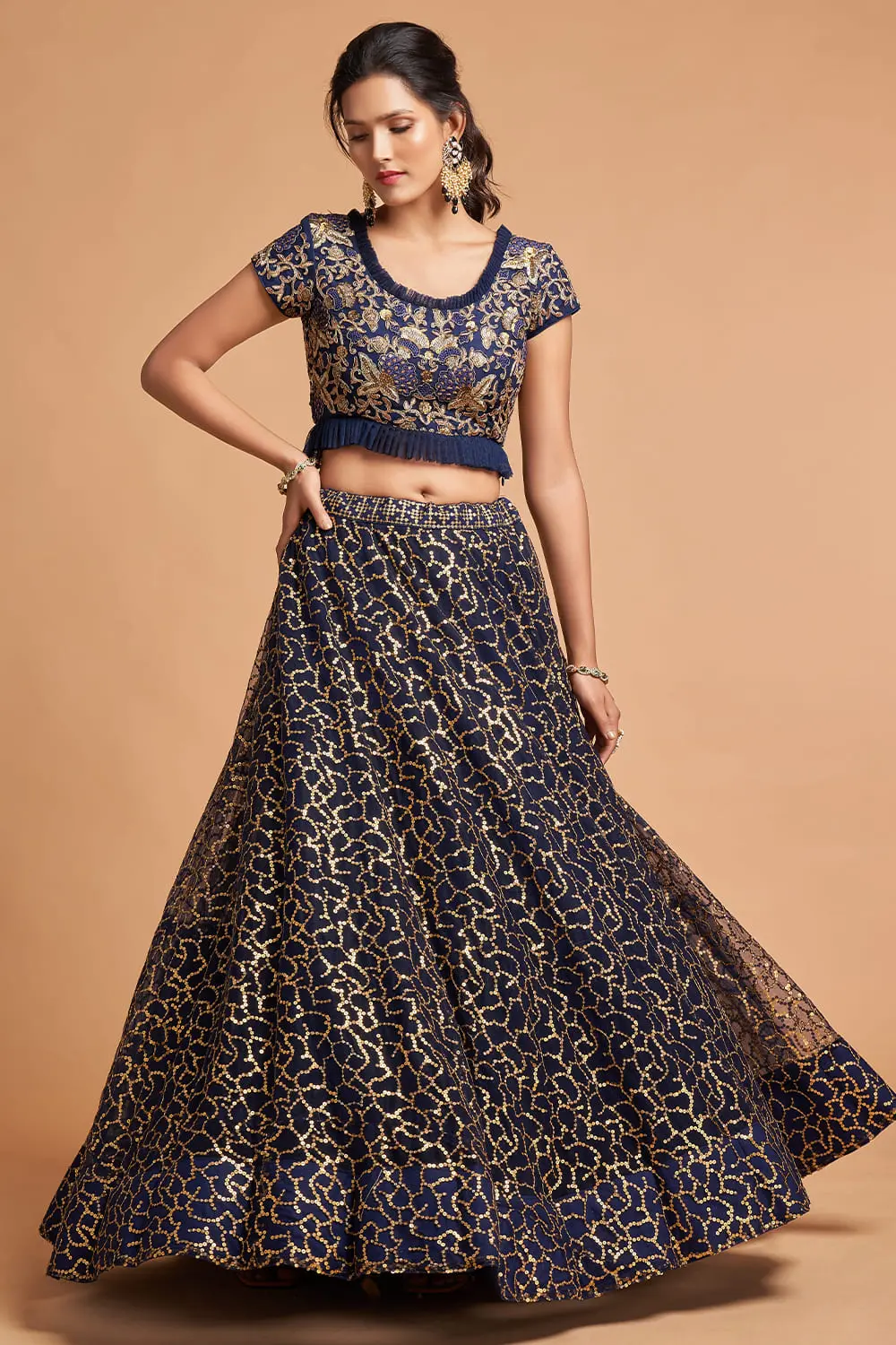 A woman twirling in the Navy Blue Net Lehenga, capturing the lightweight movement of soft net.