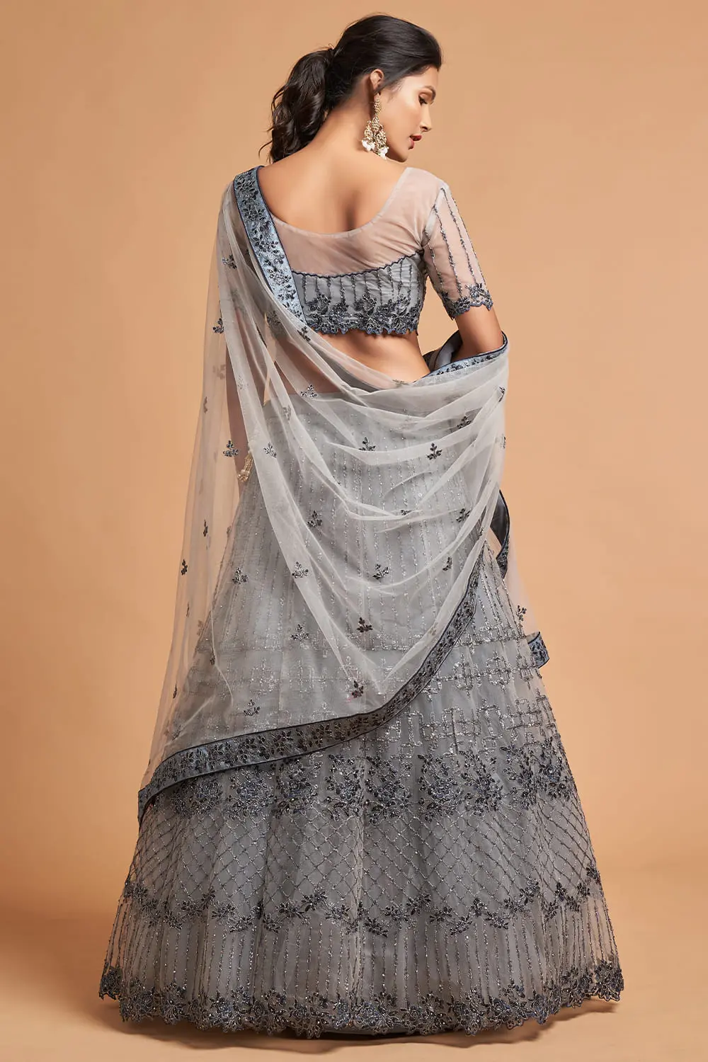 Back view of the plus-size-friendly blouse, showing the adjustable tie-up and delicate zari cuff.