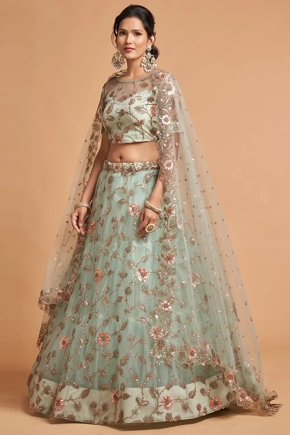 A bride twirling on a beach in the Sky Blue Net Lehenga, capturing the airy movement of the soft net.