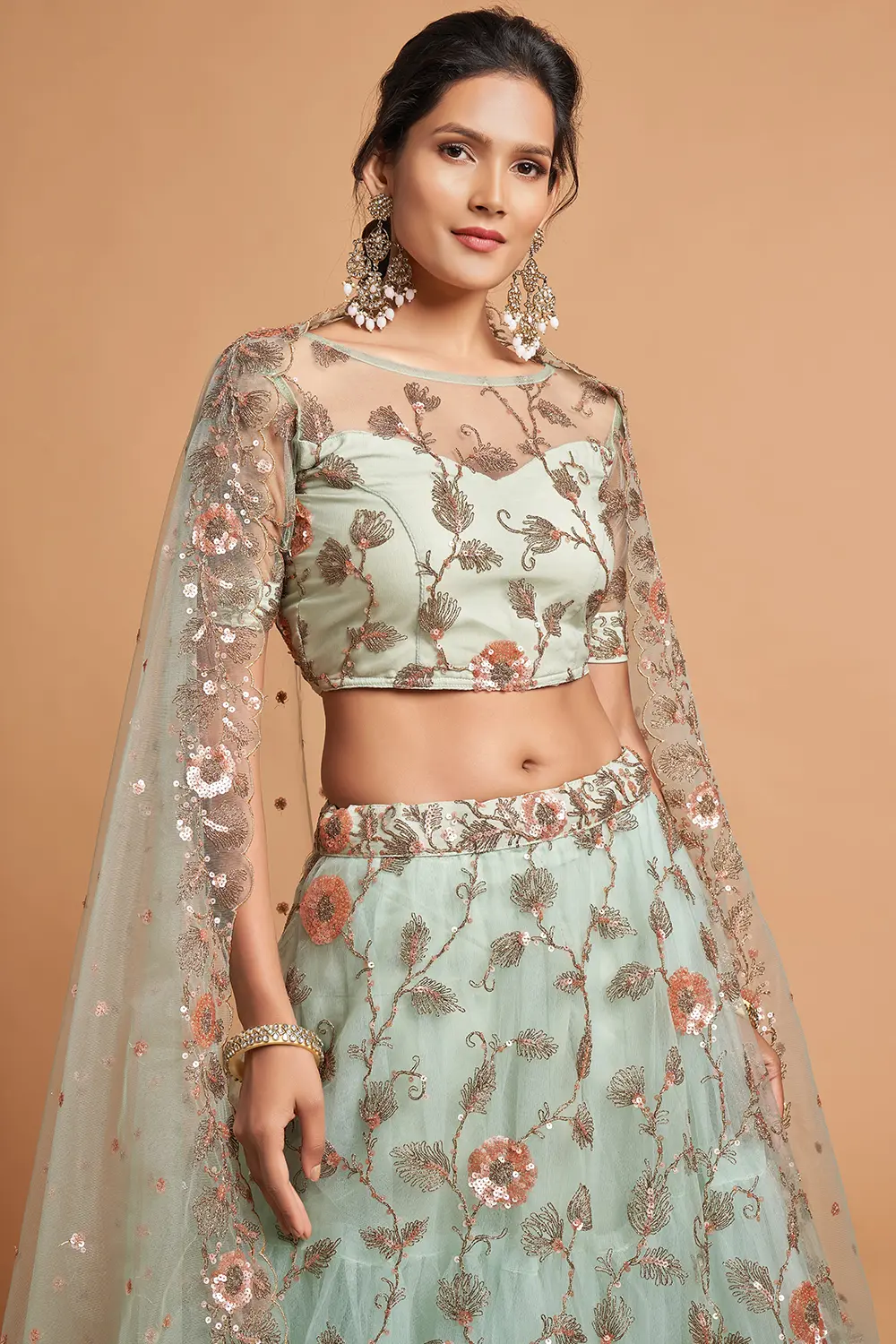 Close-up of the net lehenga skirt showing zari vine motifs and scattered sequin detail on sky blue soft net.