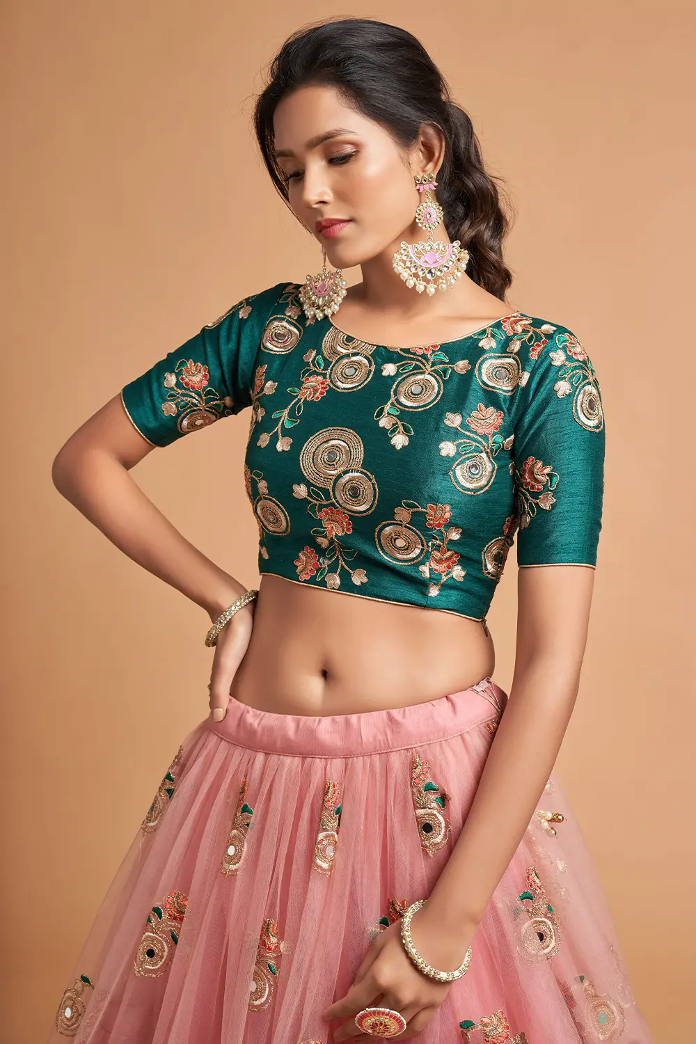 Close-up of zari mango-branch motifs and peach sequins on the Peach Net Lehengas skirt.