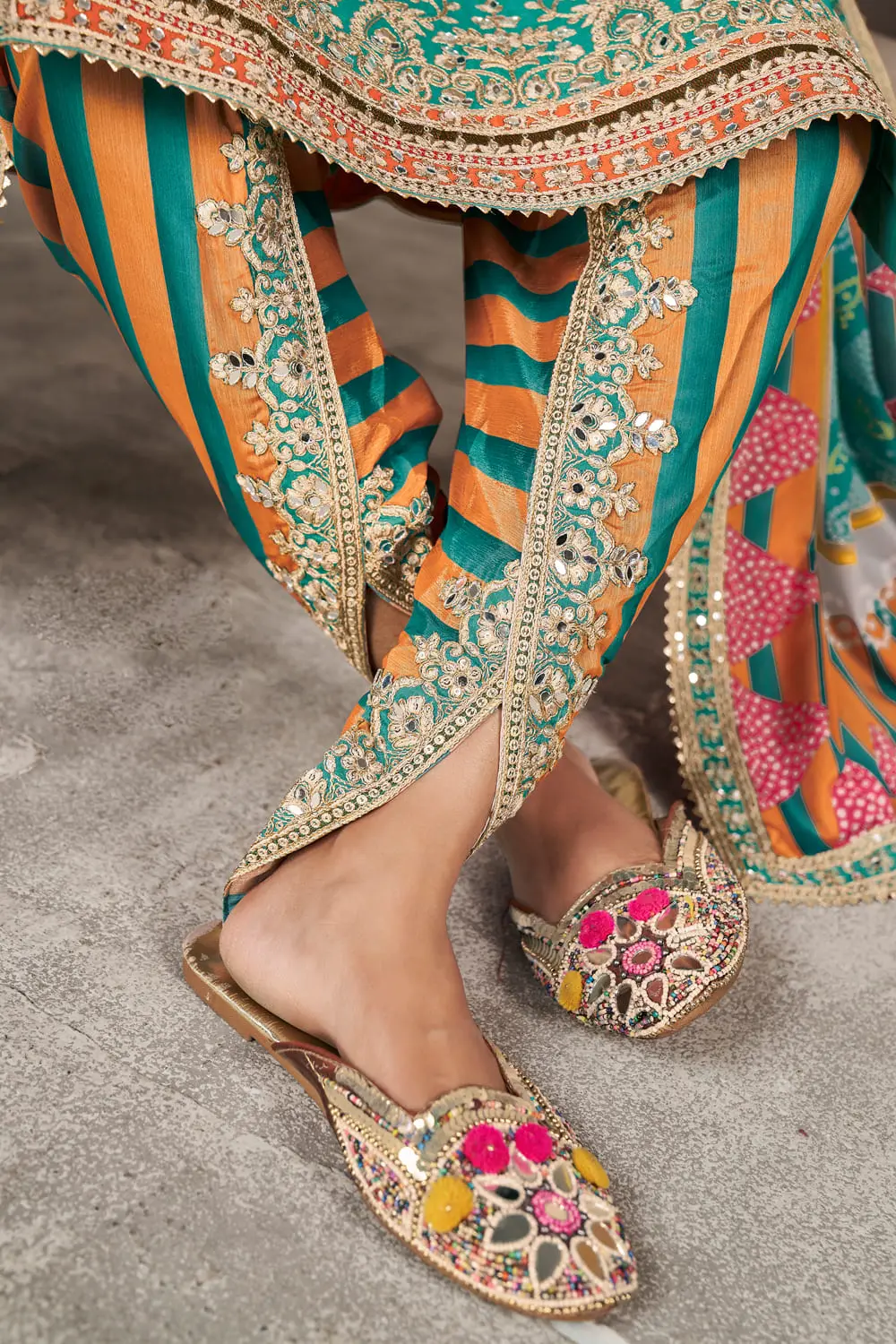 Close up of teal kurti sleeve with sequins and shisha mirror work
