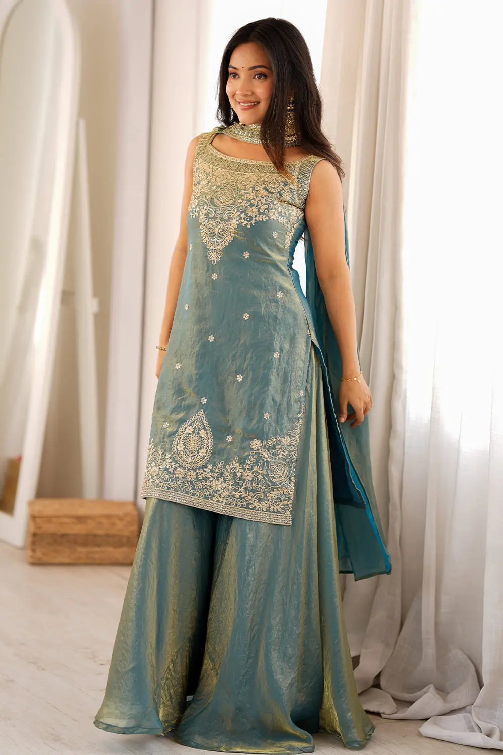 Side view of teal green silk sharara showing flared wide-leg drape