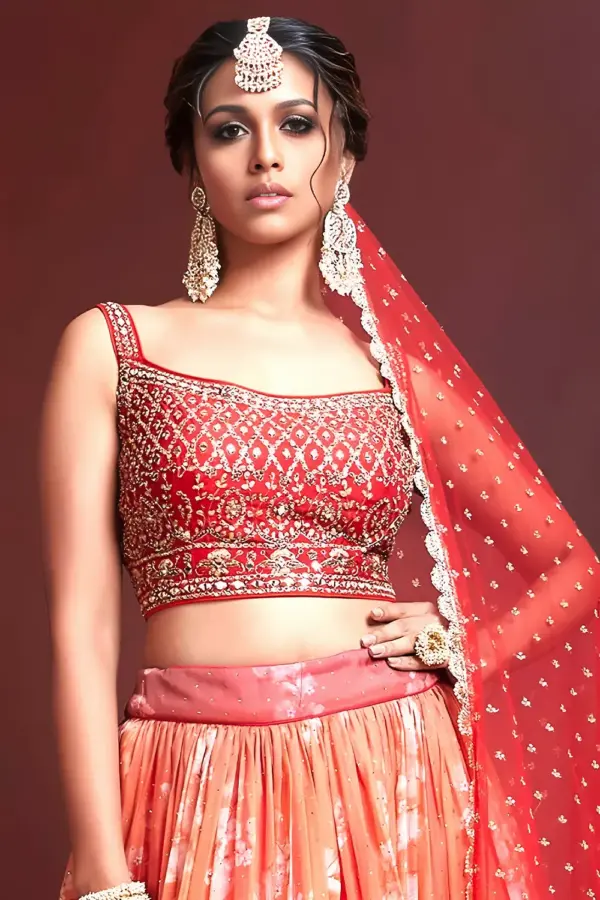 Swarovski crystals and heavy embroidery detail on orange silk lehenga