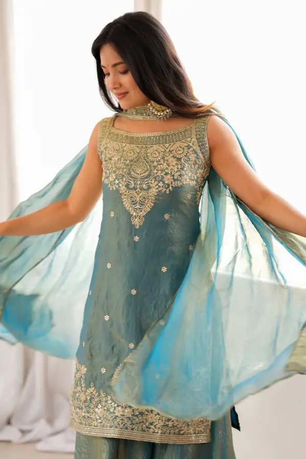 Close up of sequins, dori and zari work on teal green silk kurta